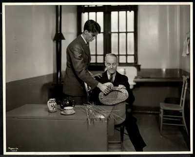 Mann unterrichtet einen anderen Mann im Korbflechten bei der New York Association for the Blind, 111 East 59th Street, New York, 1931 von Byron Company